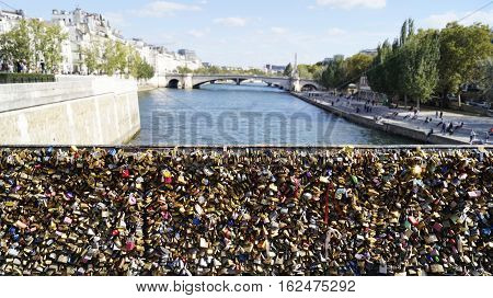 PARIS FRANCE - SEPTEMBER 27 2015: Many love locks at the Archbishop's (Pont de l'Archeveche) bridge in Paris France
