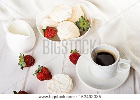 tasty zephyrs on white wooden table. sweet zephyrs and strawberry on wood background.
