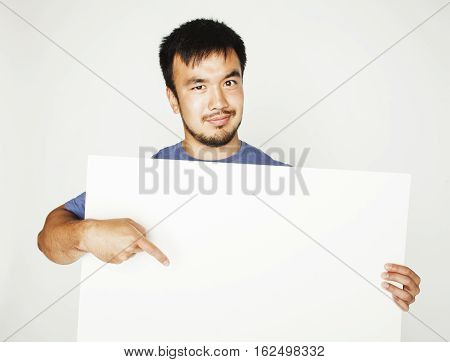 pretty cool asian man holding empty white plate smiling, making advert