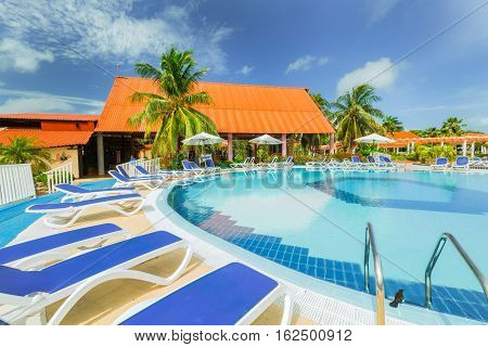Cayo Guillermo island, Sercotel resort, Cuba, July 4, 2016, beautiful inviting gorgeous lovely view of hotel grounds and swimming pool against blue sky background on sunny day