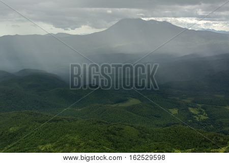 Rain in the Kronotsky Nature Reserve on Kamchatka Peninsula. View from helicopter.