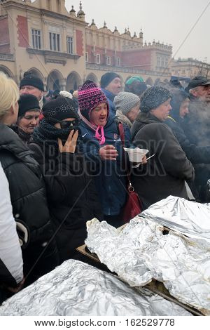 CRACOW POLAND - DECEMBER 18 2016: Christmas Eve for poor and homeless on the Central Market in Cracow. Every year the group Kosciuszko prepares the greatest eve in the open air in Poland