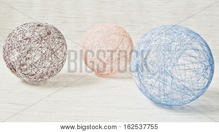 balls of yarn of different colors on a light background