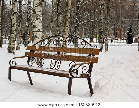 lonely bench in the frozen snow park