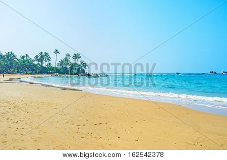The tourists enjoy swimming boat trips and surfing in Indian Ocean Hikkaduwa Sri Lanka.