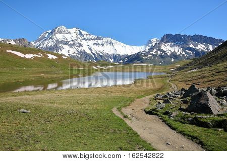 VANOISE, FRANCE : View of three summits (Grande Casse, Grande Motte and Pierre Brune) from a lake in Northern Alps