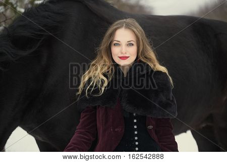 Girl In Dark Clothes With A Black Horse