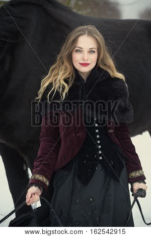 Girl In Dark Clothes With A Black Horse