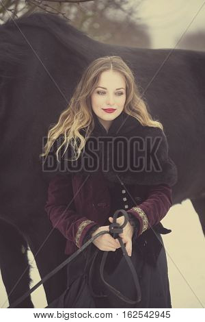 Girl In Dark Clothes With A Black Horse