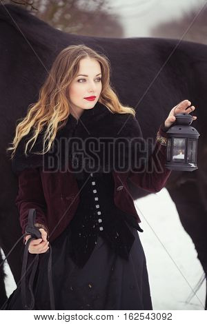 Girl In Dark Clothes With A Black Horse