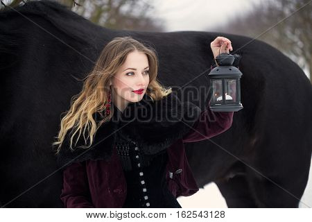 Girl In Dark Clothes With A Black Horse