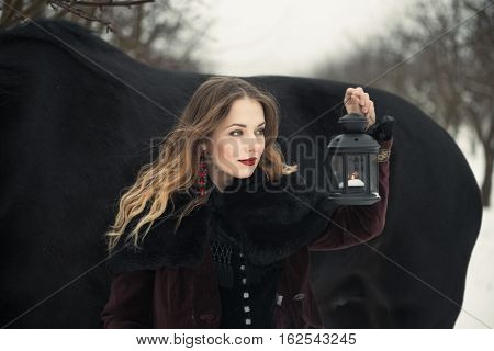Girl In Dark Clothes With A Black Horse