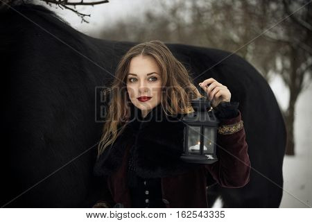 Girl In Dark Clothes With A Black Horse