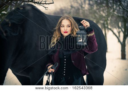 Girl In Dark Clothes With A Black Horse