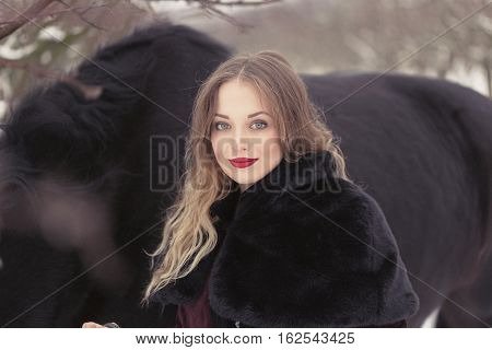 Girl In Dark Clothes With A Black Horse