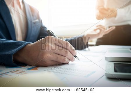Team work process. young business managers crew working with new startup project. labtop on wood table typing keyboard texting message analyze graph plans.