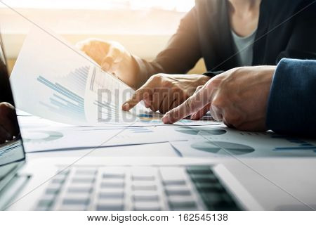Team work process. young business managers crew working with new startup project. labtop on wood table typing keyboard texting message analyze graph plans.