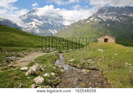 VANOISE, FRANCE :View of Grande Casse summit with St Barthelemy Chapel in the foreground, Northern Alps