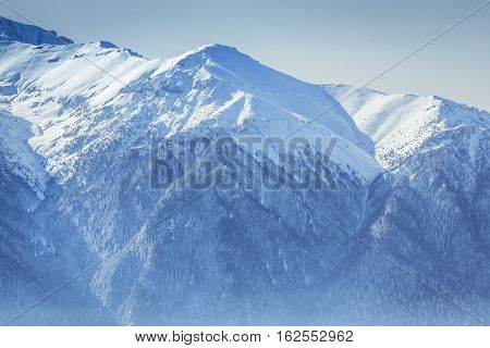 Scenic Panorma Of The Bucegi Mountains Covered By Snow In The Carpathian Mountains, Romania