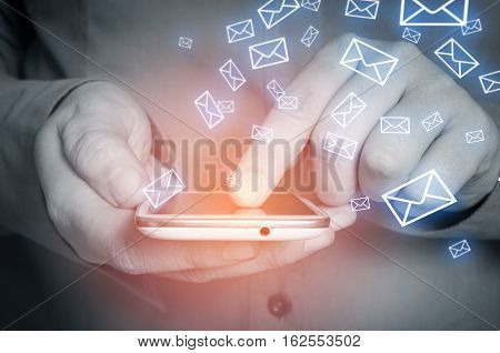 Closeup of male hand using smart phone for reading emails.