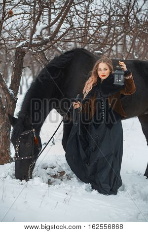 Girl In Dark Clothes With A Black Horse