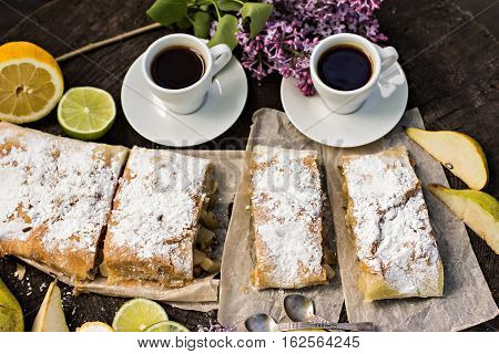 pie strudel with pear and lemon. Cup of coffee. Picnic Breakfast in nature. Food in nature.