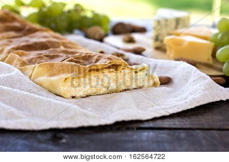 Сheese pie strudel with cheese cheese pie 4. Wine grapes nuts cheese blue cheese and coffee. dinner lunch romantic date picnic eating on nature.