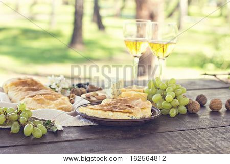 Сheese pie strudel with cheese cheese pie 4. Wine grapes nuts cheese blue cheese and coffee. dinner lunch romantic date picnic eating on nature.