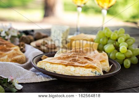 Сheese pie strudel with cheese cheese pie 4. Wine grapes nuts cheese blue cheese and coffee. dinner lunch romantic date picnic eating on nature.