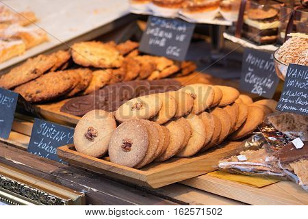 Different kinds of sweet handmade pastries ready for sale with nuts chocolate and apples