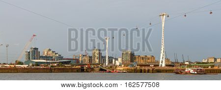 London United Kingdom - August 17: Air gondolas over River Thames on August 17 2016 in London United Kingdom. River Thames is the longest river entirely in England and the second longest in the United Kingdom