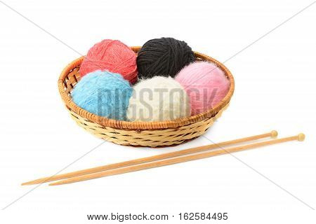 skeins of yarn and knitting needles isolated on a white background