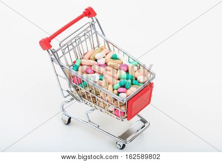 Trolley Full Of Pills On White Background