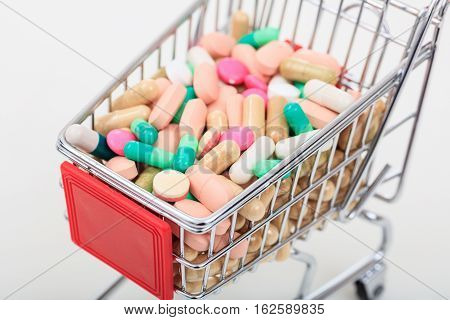 Trolley Full Of Pills On White Background