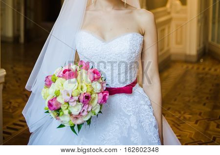 Beautiful bride with bouquet before wedding ceremony