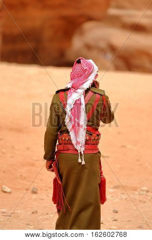 PETRA, JORDAN, MARCH 13, 2016 : A guard walking in front of The Treasury (Al Khazneh)