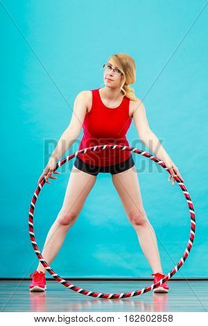 Fitness sport training and healthy lifestyle. Young woman in full length doing exercise with hula hoop girl having fun playing game hula-hoop