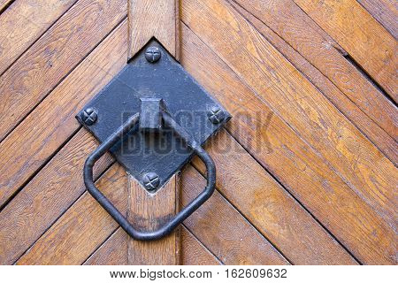 old handle on the wood brown door