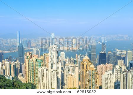 Aerial view of Victoria Harbour skyline and skyscrapers from The Sky Terrace 428, the viewing platform on top of the Peak Tower, icon building in Hong Kong.