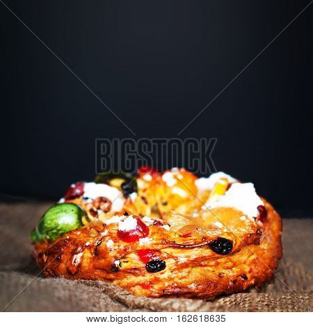 Merry Christmas cake with nuts - Bolo Rei is a traditional Xmas cake with fruits raisins nut and icing on wooden table with copy space