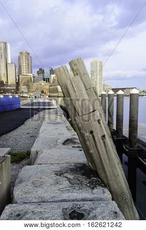 Old piling leaning against Fan Pier on Boston Harborwalk