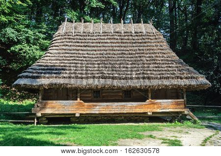 Lviv Ukraine - September 09 2016: Authentic Ukrainian wooden house with thatched roof from Oriavchik village Boyko's region Ukraine. Now in Museum of Folk Architecture in Lviv