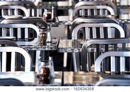 gleaming metal tables and chairs in a casual cafe
