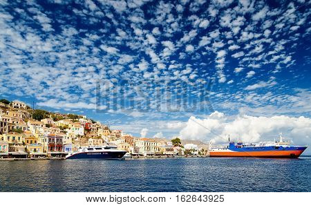 Greece. Dodecanesse. Island Symi Simi . Colorful houses on rocks