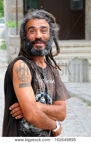 SOZOPOL BULGARIA - SEPTEMBER 7 2016: Portrait of a smiling happy man with dreadlocks