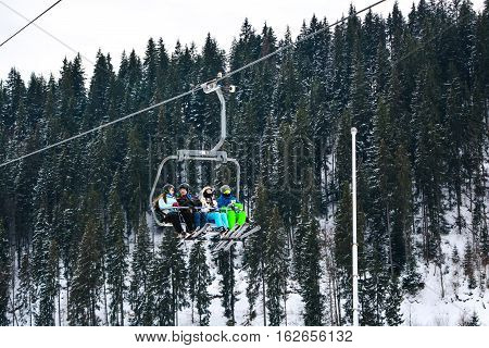 BUKOVEL, UKRAINE - December 17, 2016 : Skiers on a cable car in Bukovel. Bukovel is the most popular ski resort in Ukraine. Ski season and Winter sports concept