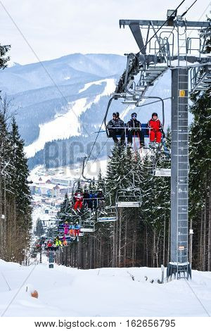 BUKOVEL, UKRAINE - December 17, 2016 : Skiers on a cable car in Bukovel. Bukovel is the most popular ski resort in Ukraine. Ski season and Winter sports concept