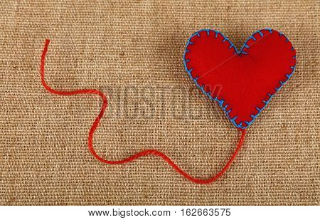 Red Felt Craft Heart Over Canvas Close Up