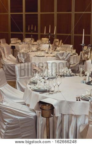 Empty plate glasses and silverware set on white table