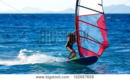 windsurfer close-up on the crest of a wave rotates